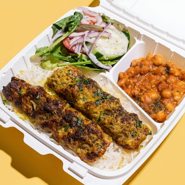 Sheesh Grill's kofta kebab meal with rice, chickpea stew, and a side salad in a takeout container.