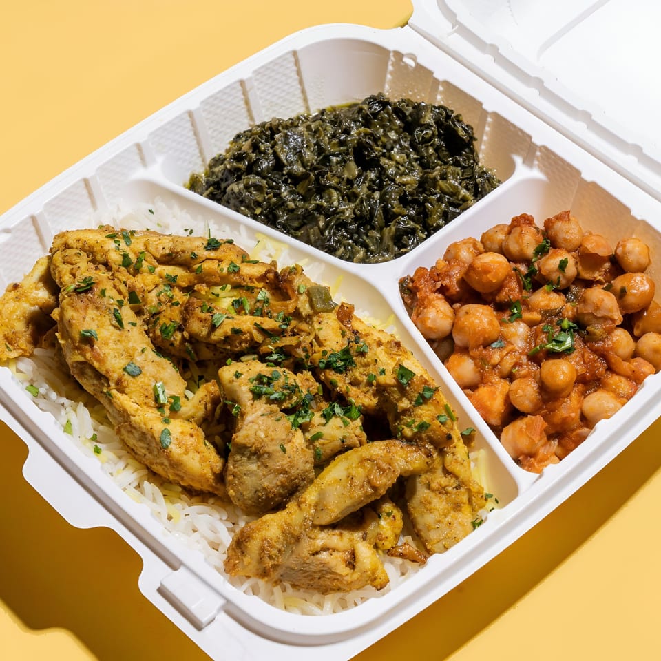 Sheesh Grill's middle-eastern takeout meal with chicken, rice, chickpeas, and spinach in a white container.
