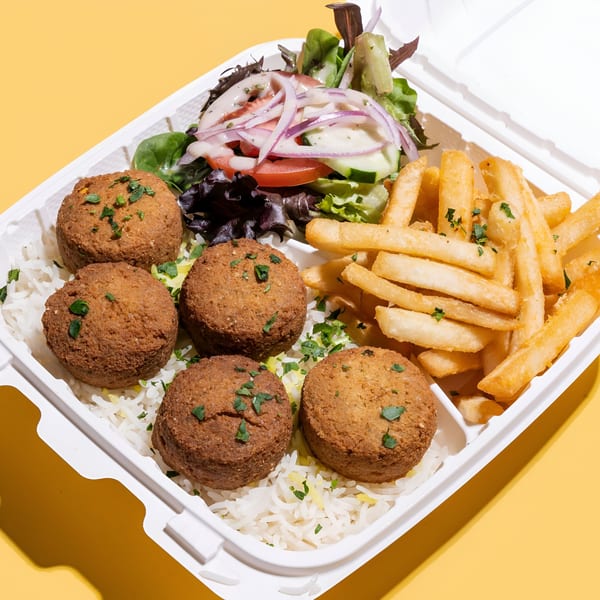 Sheesh Grill falafel platter with rice, fries, and salad in a white takeout container.