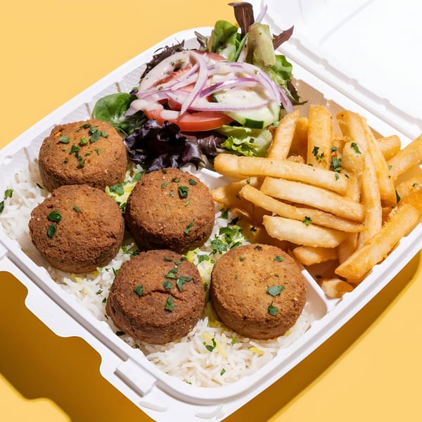Sheesh Grill falafel platter with rice, fries, and salad in a white takeout container.
